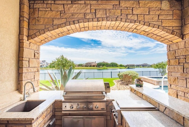 5716 S Oso Pkwy, Corpus Christi, TX 78414 - fenced backyard with a sink, a water view, and a pool with connected hot tub