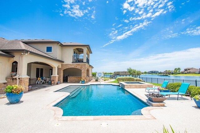 5716 S Oso Pkwy, Corpus Christi, TX 78414 - view of pool featuring a patio, a water view, and a pool with connected hot tub