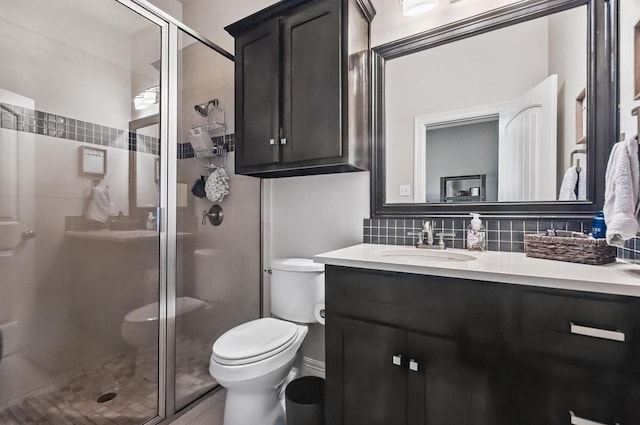 5716 S Oso Pkwy, Corpus Christi, TX 78414 - bathroom with toilet, a stall shower, vanity, and tasteful backsplash