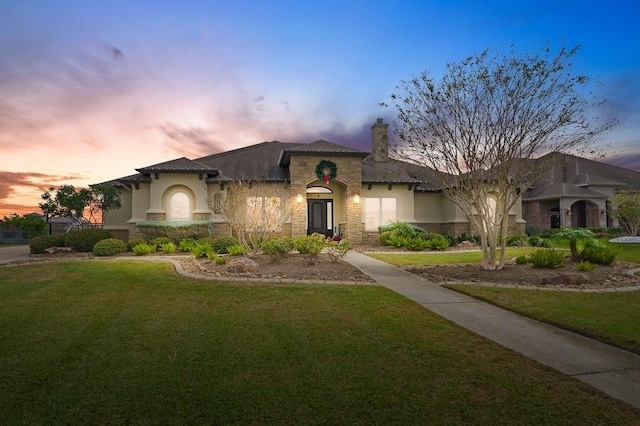 5716 S Oso Pkwy, Corpus Christi, TX 78414 - mediterranean / spanish-style house with stone siding, a yard, stucco siding, and a chimney