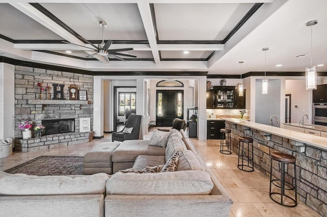 5716 S Oso Pkwy, Corpus Christi, TX 78414 - living area with crown molding, ceiling fan, beam ceiling, coffered ceiling, and recessed lighting