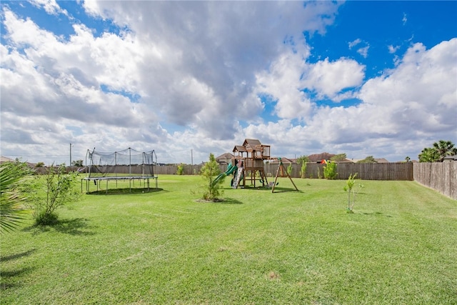 view of yard featuring a playground and a trampoline