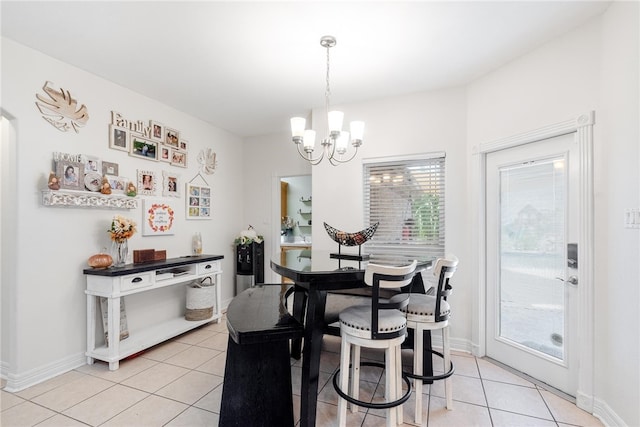 tiled dining room with a chandelier