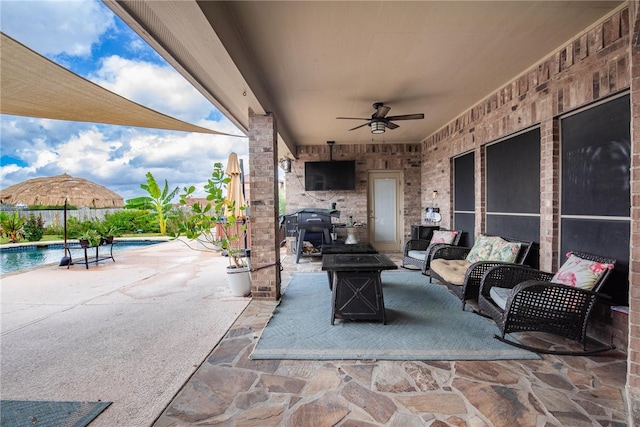 view of patio featuring outdoor lounge area, a mountain view, and ceiling fan