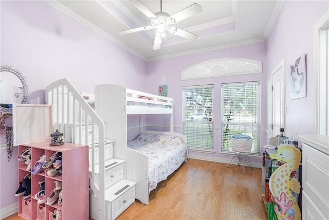 5309 Fox Glove, Corpus Christi, TX 78413 - bedroom with light wood-type flooring, crown molding, ceiling fan, baseboards, and a tray ceiling