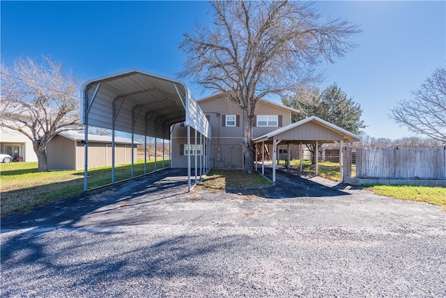 view of front of home featuring a front lawn and a carport