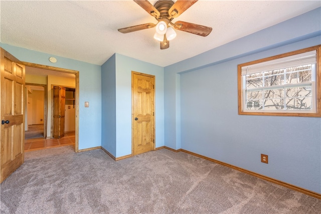 unfurnished bedroom with carpet flooring, a textured ceiling, and ceiling fan