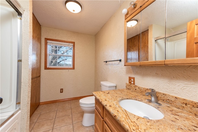 full bathroom featuring tile patterned floors, vanity, a textured ceiling, tub / shower combination, and toilet