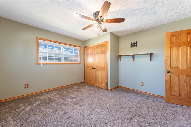 unfurnished bedroom featuring a textured ceiling, carpet floors, ceiling fan, and a closet