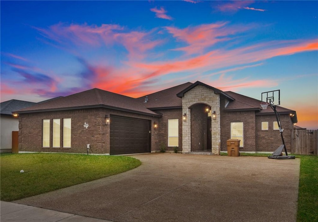 view of front of property with a lawn and a garage