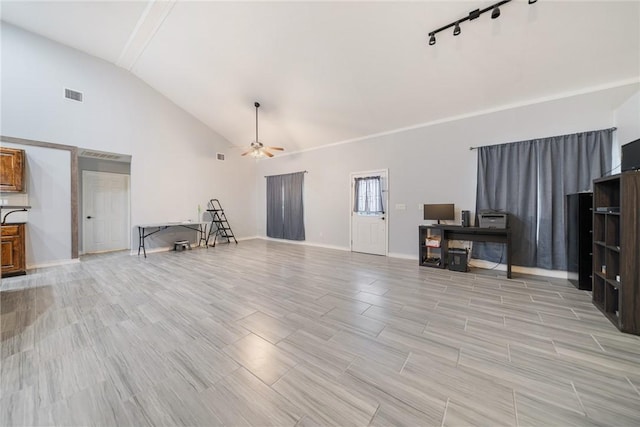 living room with ceiling fan, vaulted ceiling, and track lighting