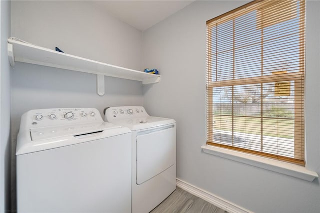 washroom with washer and dryer and light hardwood / wood-style floors