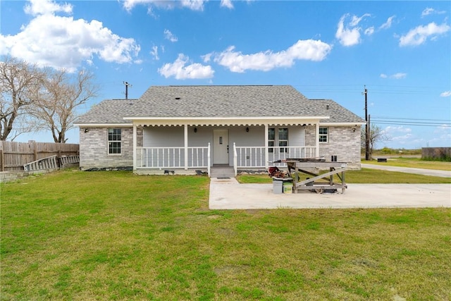 rear view of house with a lawn, a patio, and a porch