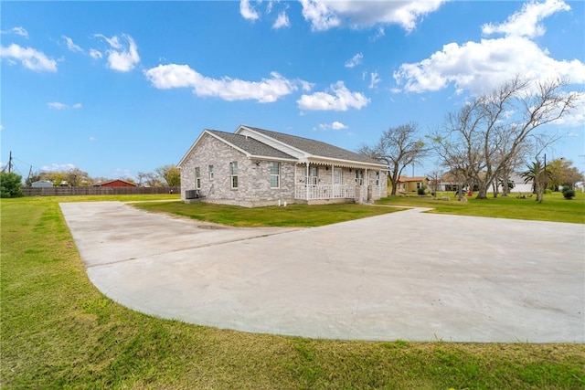 view of property exterior with a lawn and central AC unit