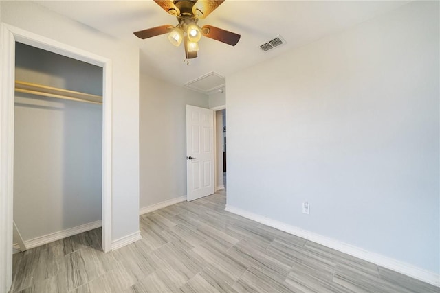 unfurnished bedroom with ceiling fan, a closet, and light hardwood / wood-style flooring