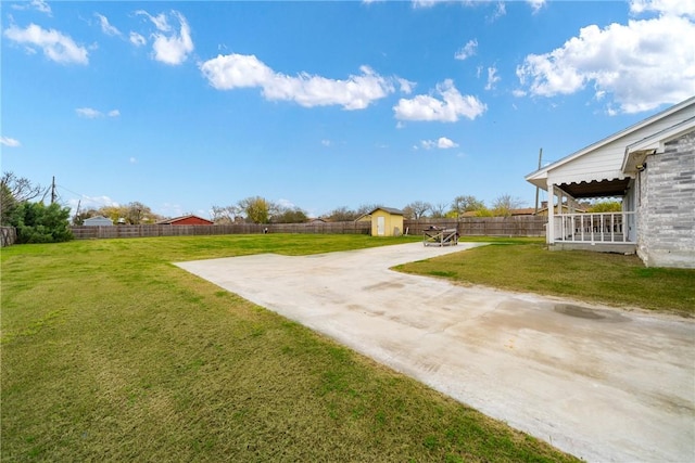 view of yard featuring a patio and a storage unit