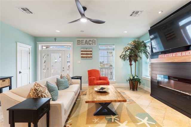 living room with ceiling fan and light tile patterned floors