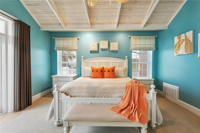 bedroom with wood ceiling, light colored carpet, and multiple windows