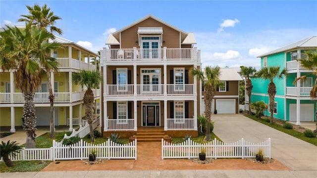 coastal inspired home featuring a balcony, a garage, and covered porch