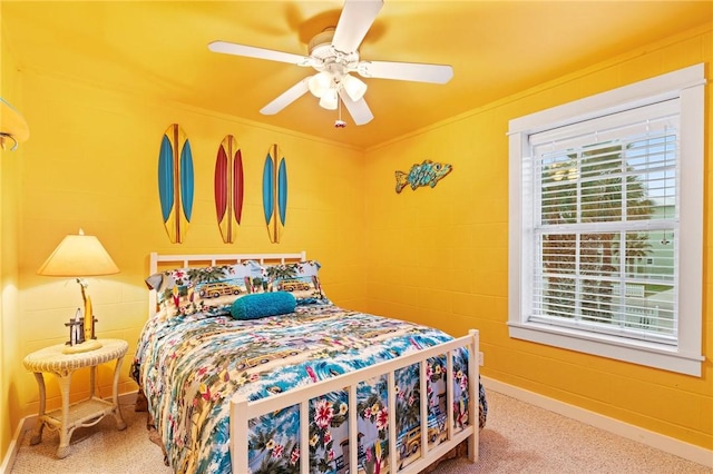 carpeted bedroom featuring ceiling fan and ornamental molding