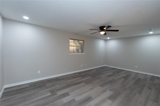 empty room with ceiling fan and dark hardwood / wood-style flooring