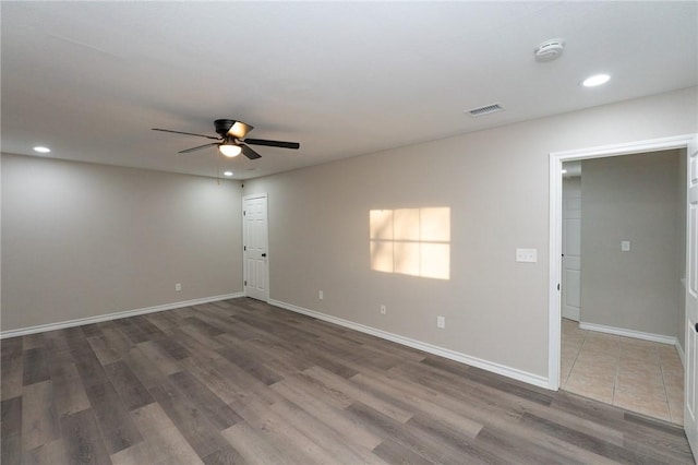 empty room featuring ceiling fan and dark hardwood / wood-style flooring