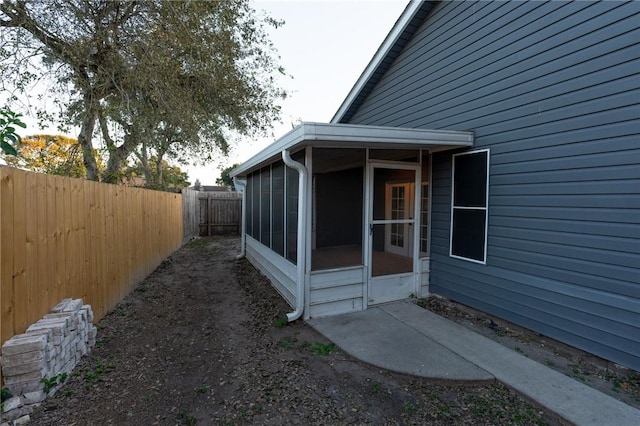 view of property exterior with a sunroom