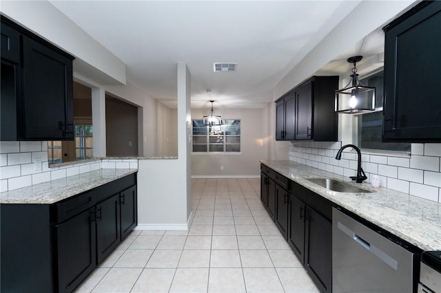 kitchen featuring light stone countertops, sink, hanging light fixtures, and stainless steel dishwasher