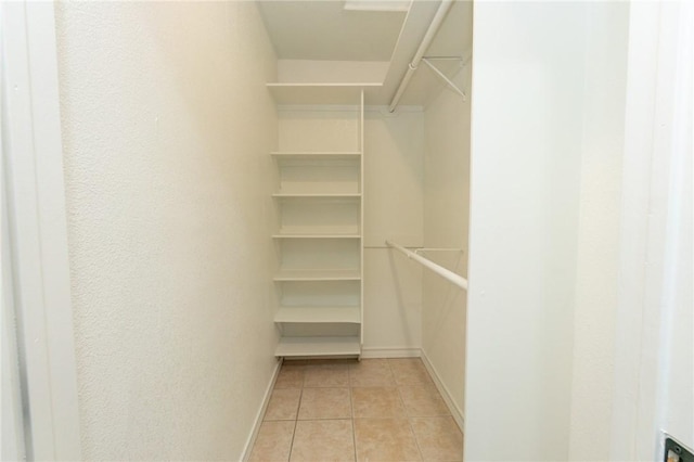 walk in closet featuring light tile patterned floors