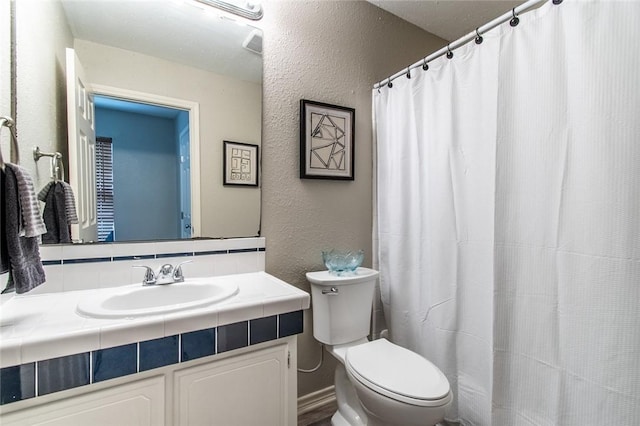 7322 Milky Way Dr, Corpus Christi, TX 78412 - full bathroom featuring a textured wall, vanity, tasteful backsplash, and curtained shower