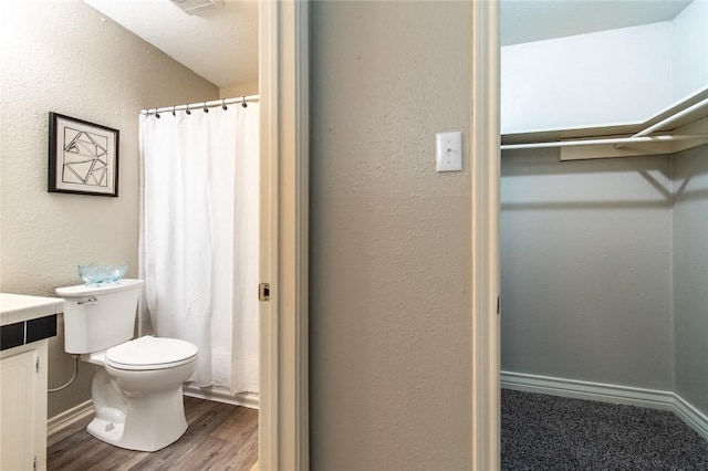 7322 Milky Way Dr, Corpus Christi, TX 78412 - full bath featuring vanity, wood finished floors, curtained shower, and a textured wall