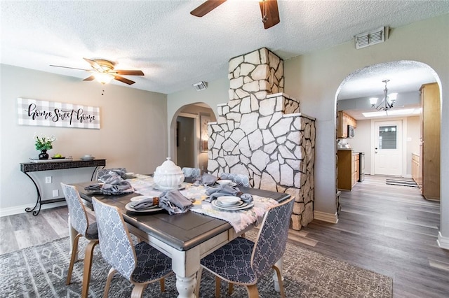 7322 Milky Way Dr, Corpus Christi, TX 78412 - dining space featuring arched walkways, a ceiling fan, a chandelier, wood finished floors, and a textured ceiling