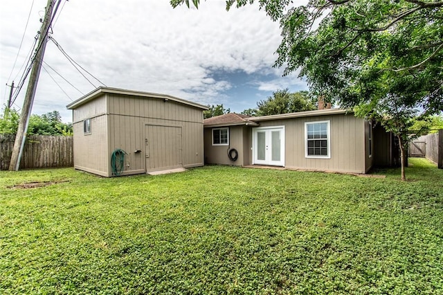 7322 Milky Way Dr, Corpus Christi, TX 78412 - rear view of house featuring french doors, a fenced backyard, and a storage unit