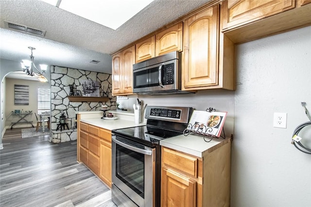 7322 Milky Way Dr, Corpus Christi, TX 78412 - kitchen with stainless steel appliances, a textured ceiling, light countertops, a chandelier, and light wood-style flooring