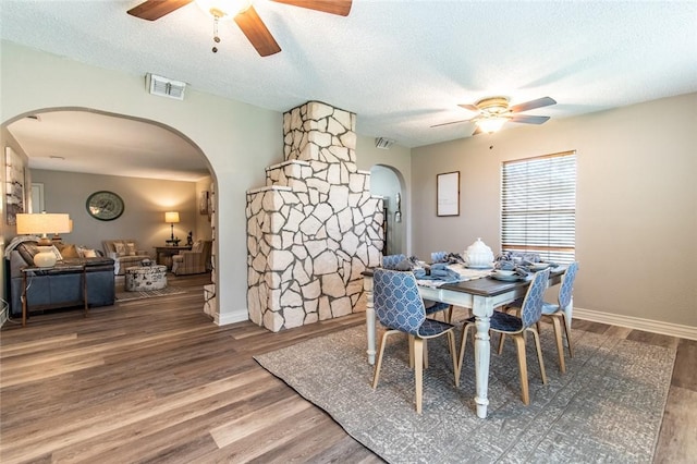 7322 Milky Way Dr, Corpus Christi, TX 78412 - dining space with a ceiling fan, arched walkways, wood finished floors, and a textured ceiling