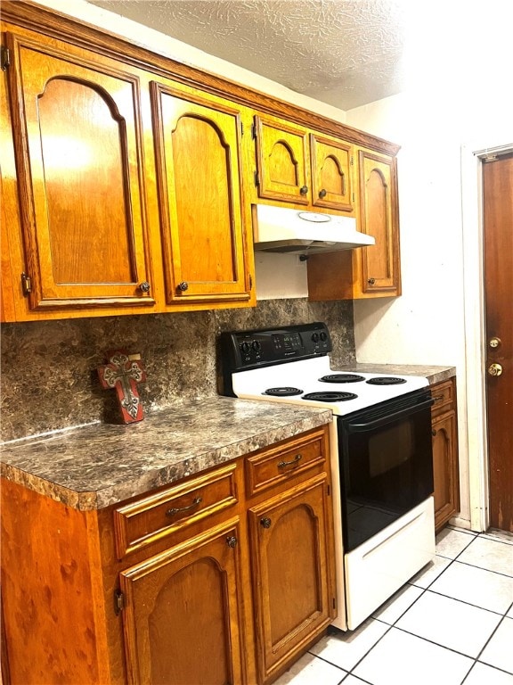 kitchen with backsplash, a textured ceiling, light tile patterned floors, and electric range