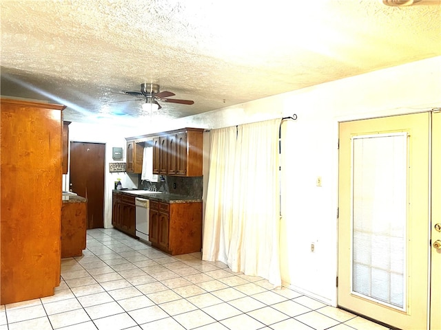 kitchen featuring light tile patterned flooring, ceiling fan, decorative backsplash, and white dishwasher