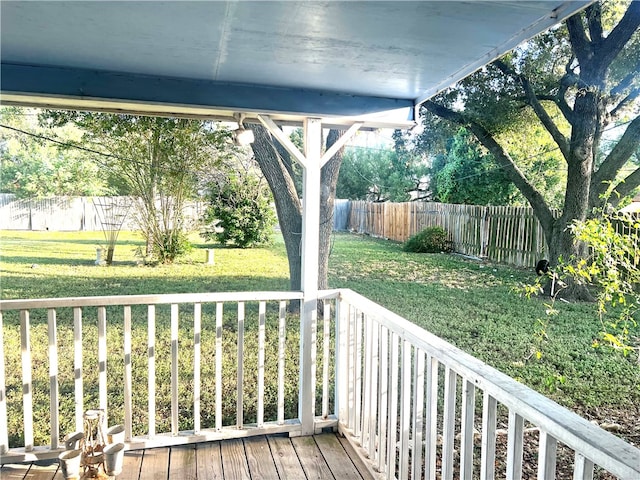 wooden deck featuring a lawn