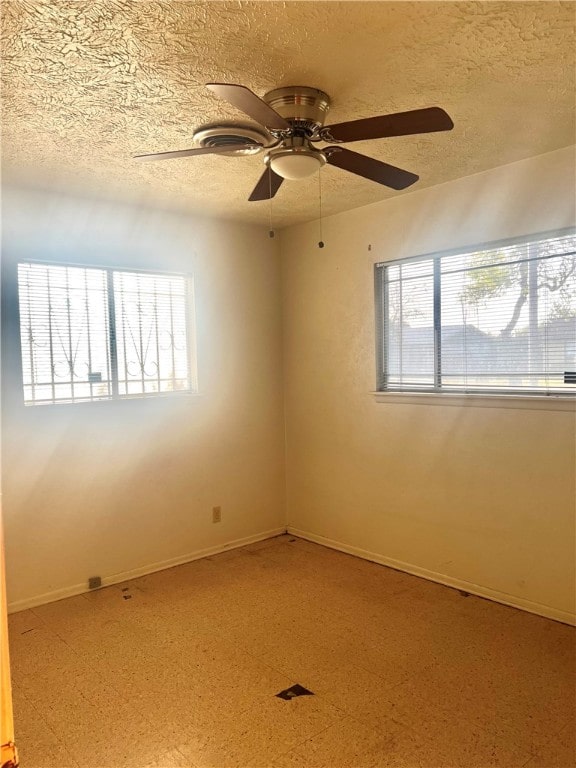 empty room featuring a textured ceiling, ceiling fan, and plenty of natural light