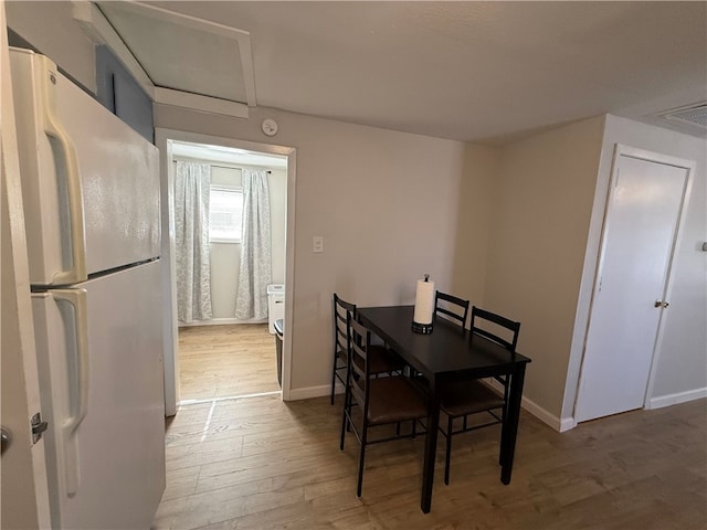 dining room with light wood-type flooring