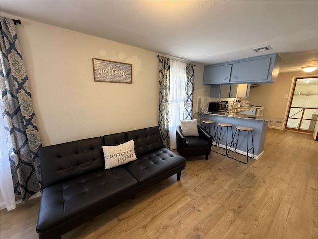 living room with light hardwood / wood-style floors