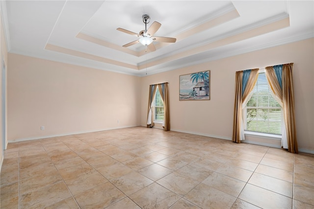 unfurnished room featuring ceiling fan, a raised ceiling, and ornamental molding