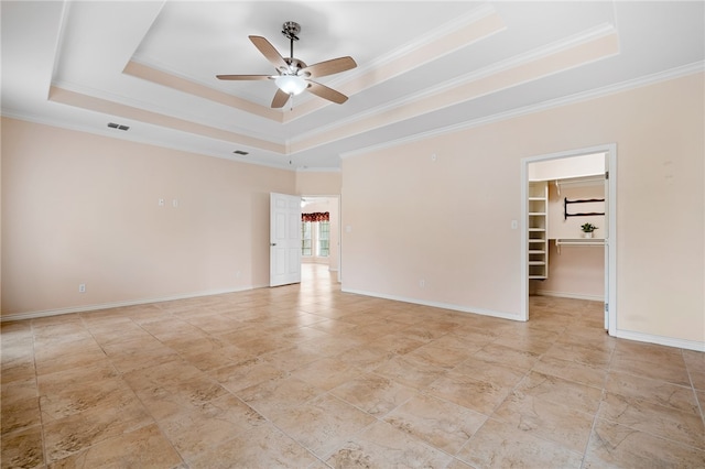 unfurnished room with ceiling fan, crown molding, and a tray ceiling