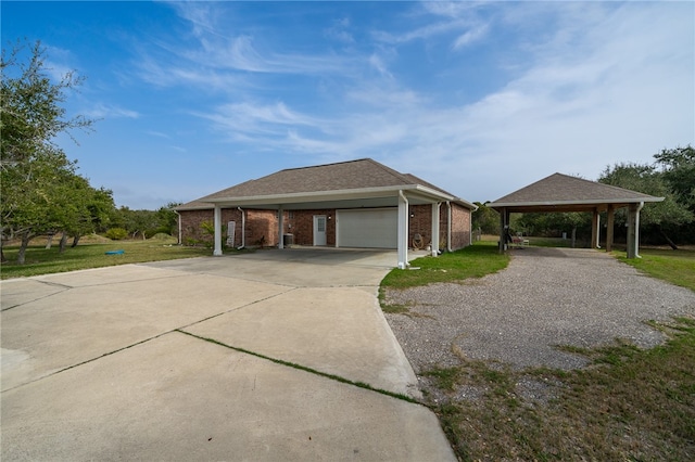 view of front of home with a garage, a front yard, and a carport