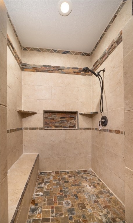 bathroom featuring a tile shower