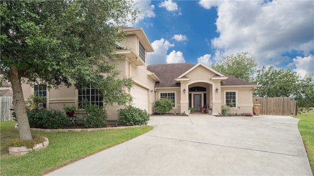 view of front of house featuring a garage and a front lawn