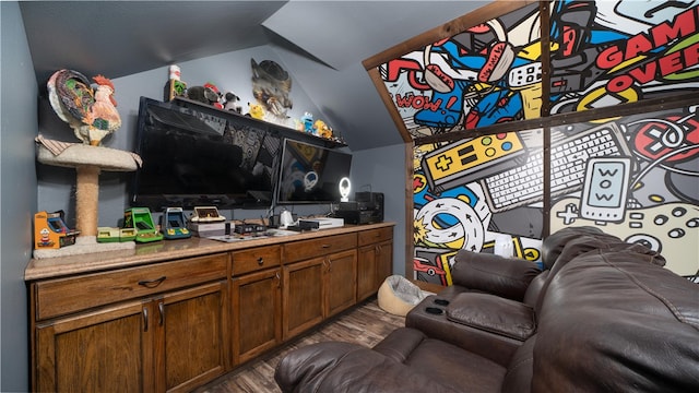 interior space featuring dark hardwood / wood-style flooring and lofted ceiling