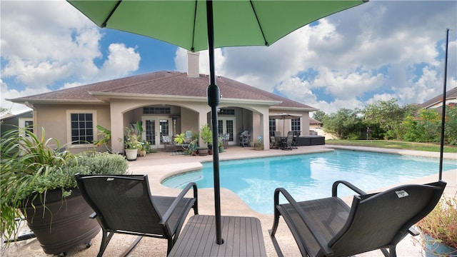 view of swimming pool featuring a patio, french doors, and a grill