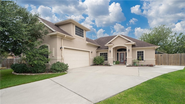 view of front facade with a front yard and a garage