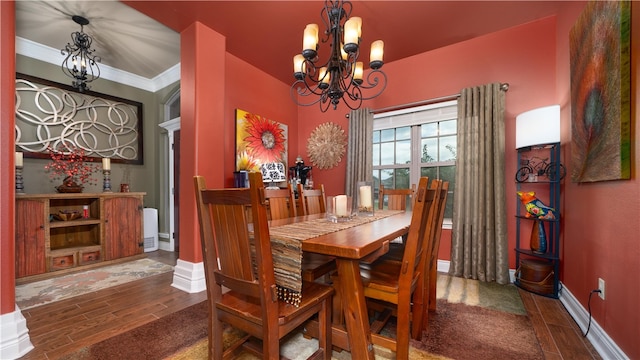 dining space featuring a chandelier, wood-type flooring, and crown molding